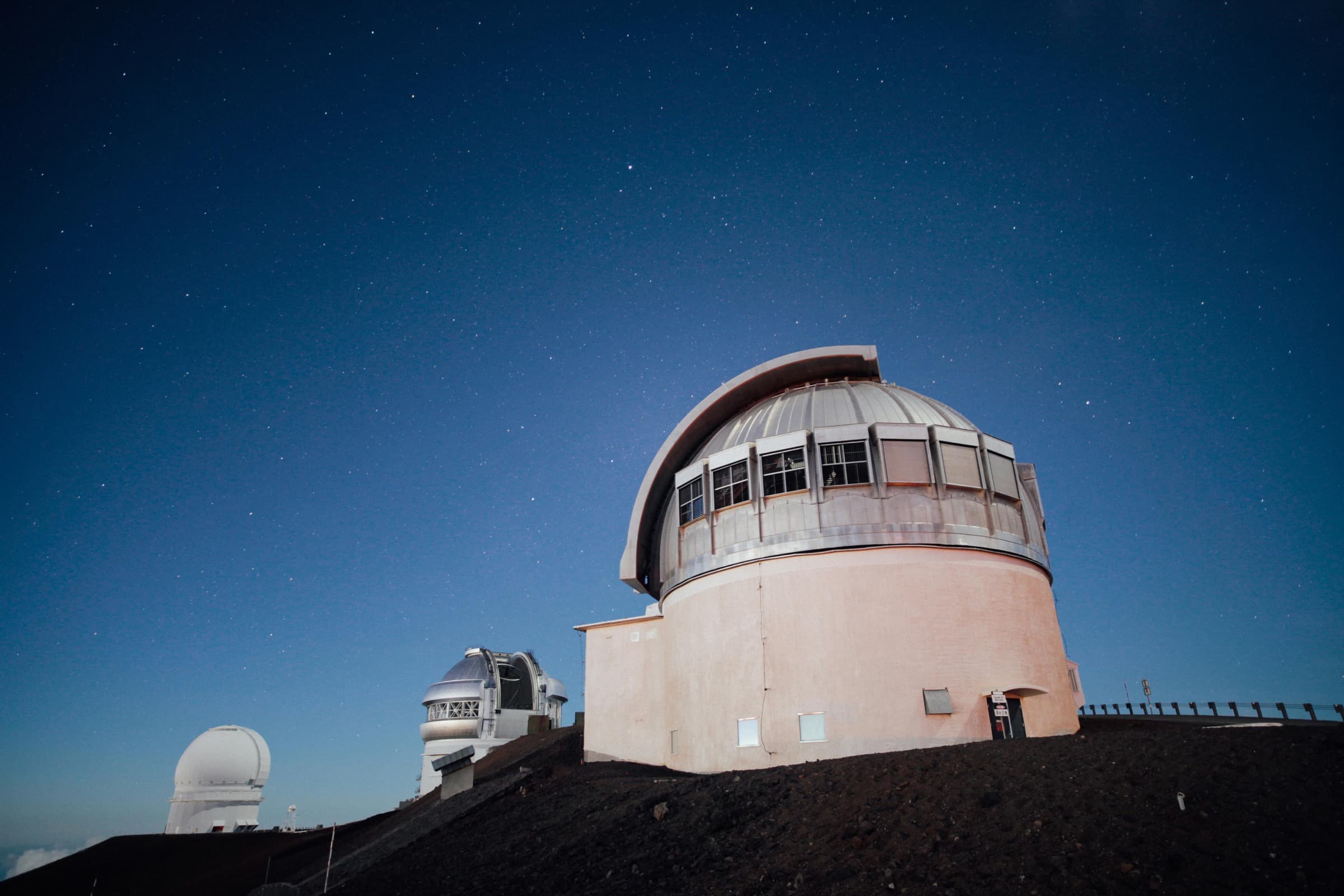 An observatory beneath a clear night sky filled with stars